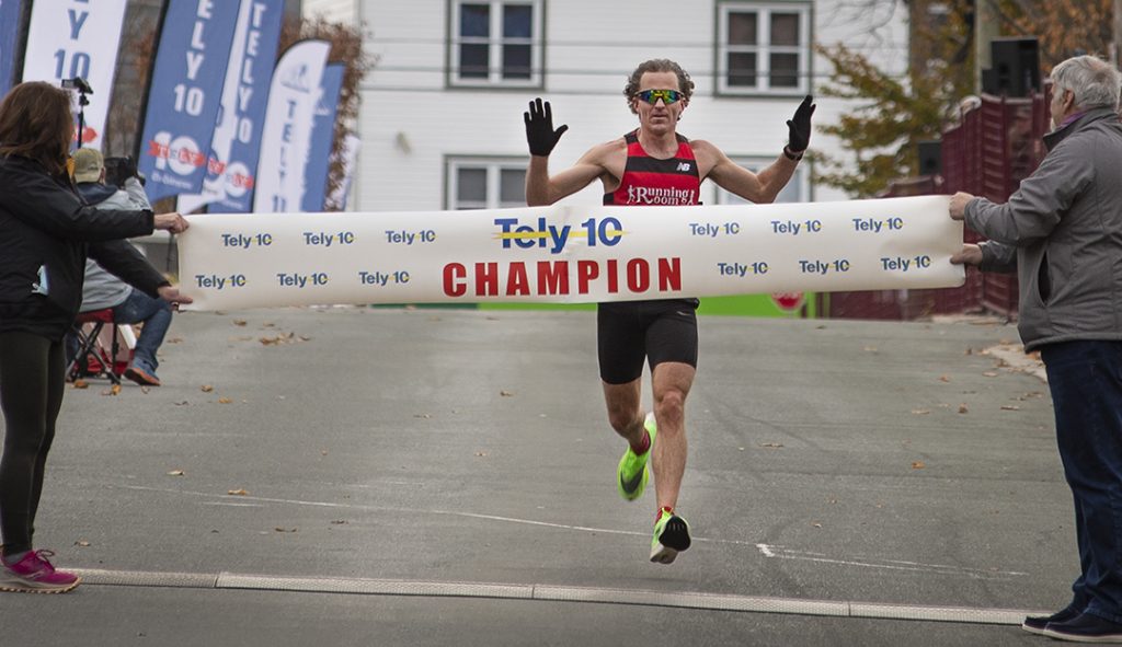 Colin Fewer crossing the finish line to win the 2021 Tely 10 ten mile road race in a time of 50:52. Photo by Greg Locke / Stray Light Media